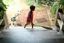 Community Work Student cleans the front of a building