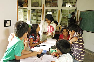 Physics Class Students and Teachers work on a science project